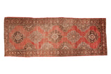 Vintage Oushak runner features scalloped medallions on an abrash-rich coral red field, 5x13.
