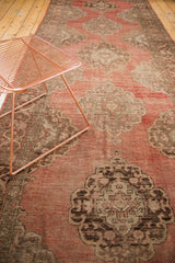Vintage Oushak runner, scalloped Rococo medallion and blush to cinnabar abrash field.
