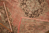 Vintage Oushak runner folded to show hand-knotted back, secured edge, and blush medallion.