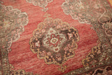 Vintage Oushak rug abrash in blush to cinnabar red field with chocolate and ivory medallions.