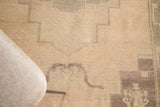 Primitive geometric patterns of a vintage Oushak rug in cream, sea foam green, charcoal.