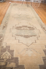 Hand-knotted Oushak detail: geometric medallion in cream, pale sea foam green, and charcoal.