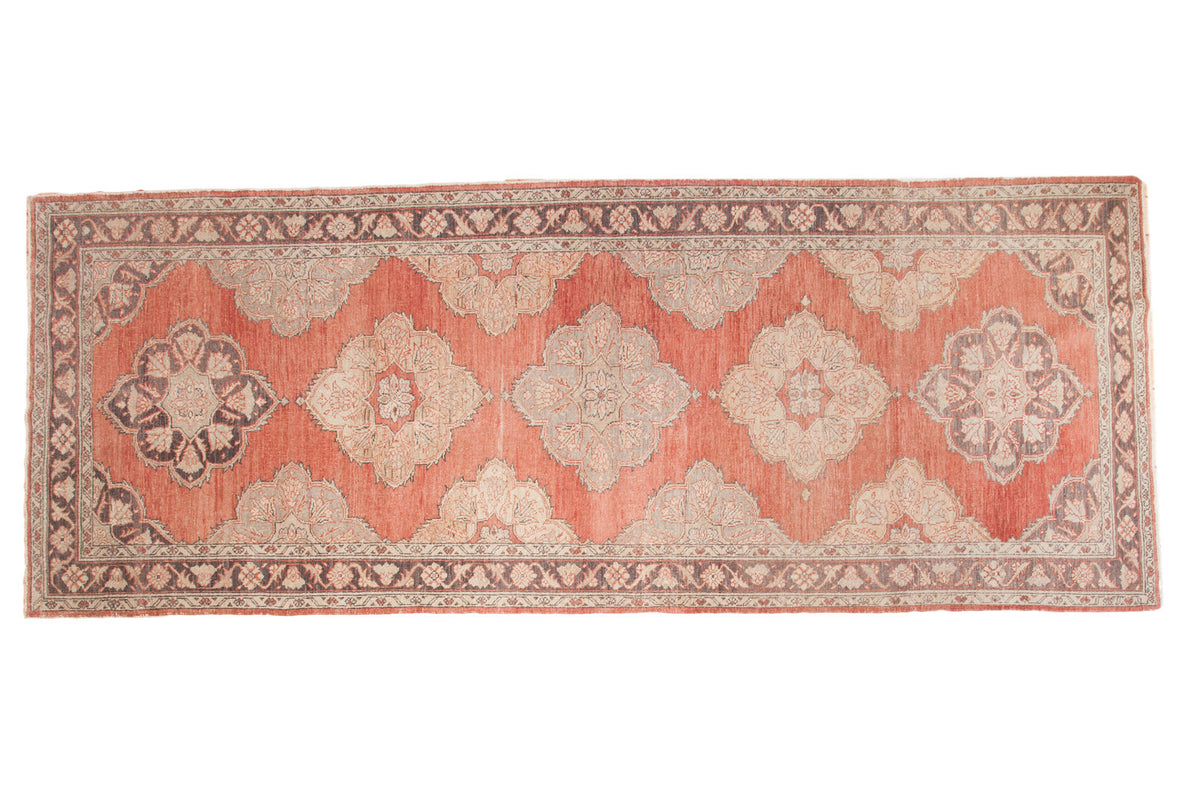 Vintage Turkish Sparta runner with cinnabar red field and blossoming floral medallions, 5'1" x 13'1".