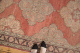 Scalloped pale gold and charcoal floral medallions on cinnabar red field of Sparta runner.