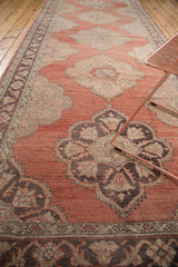 Curvilinear medallion and floral detail in charcoal, pale gold, and cinnabar red.