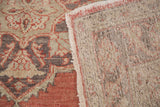 Vintage Sparta runner edge showing cinnabar red field, charcoal motifs, and woven foundation.