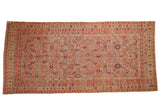 Distressed vintage Malayer runner, allover Herati motif on orange-red field with vibrant accents.