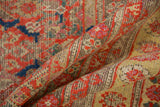 Distressed hand-knotted texture with vivid red, blue, and pink Herati motifs on vintage Malayer.