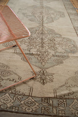Vintage Oushak runner with intricate slate and brown geometric pattern on ivory field.