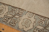 Secured border of vintage Oushak rug runner, slate and antique ivory geometric pattern.