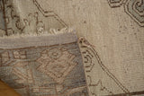 Hand-knotted construction, low pile, and fringed edge of a vintage Oushak runner.