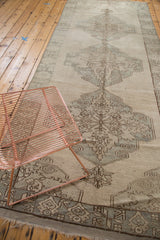 Vintage Oushak runner's end, with a slate geometric border and natural ivory fringe.