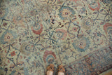 Distressed antique Mahal carpet field with faded sky blue, blush, and ivory floral arrangements.
