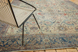 Distressed Mahal rug's field with pale saffron, ivory, blush floral motifs and navy border.