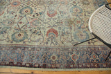 Distressed antique Mahal's faded floral field meets an intricate navy blue border.