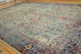 Distressed Antique Mahal carpet corner, featuring splayed floral motifs and a rich navy border.