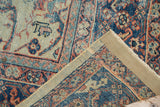 Antique Mahal rug corner, revealing hand-knotted reverse, secured edge, and blue, yellow floral motifs.