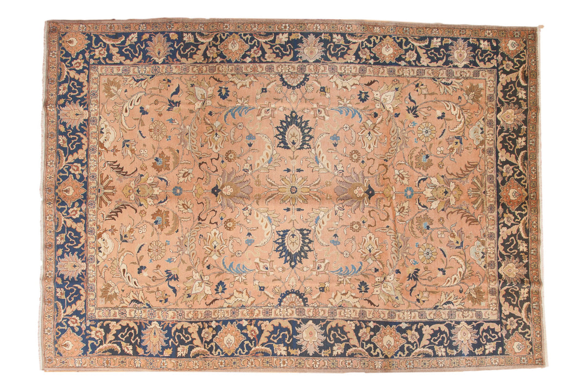 Vintage Tabriz carpet: peach apricot field with ornate floral design, navy blue border. 8'11" x 12'7".