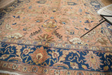 Vintage Tabriz carpet detail: peach apricot field, navy border, splayed palmettes, cloud band.