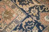 Navy blue and peach apricot fields with scrolling palmettes, lotus, and cloud band motifs.