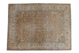 Distressed Romanian carpet with faded bronze allover floral field and antique ivory border.