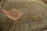 Detailed border of faded bronze Romanian carpet featuring palmettes, cloud band, and delicate florals.
