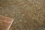 Distressed Romanian carpet; delicate ivory, blush, and navy floral vinery on faded bronze.