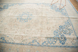 Distressed Sivas carpet corner showing faded aqua blue floral motifs and varied texture.