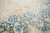 Aqua blue and sand floral motifs with worn distress on a vintage Sivas carpet.