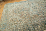 Detail of distressed Karaja rug showing geometric Herati style motifs, soft blues, and sand tones.