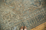 Distressed Persian Karaja carpet with blanched sand, ivory, and faded blue Herati motifs.