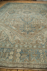 Distressed Karaja carpet detail: faded powder blue blossoming flowers and serrated leaves.