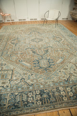 Detailed corner of a distressed Karaja rug, with geometric dark and faded blue border design.