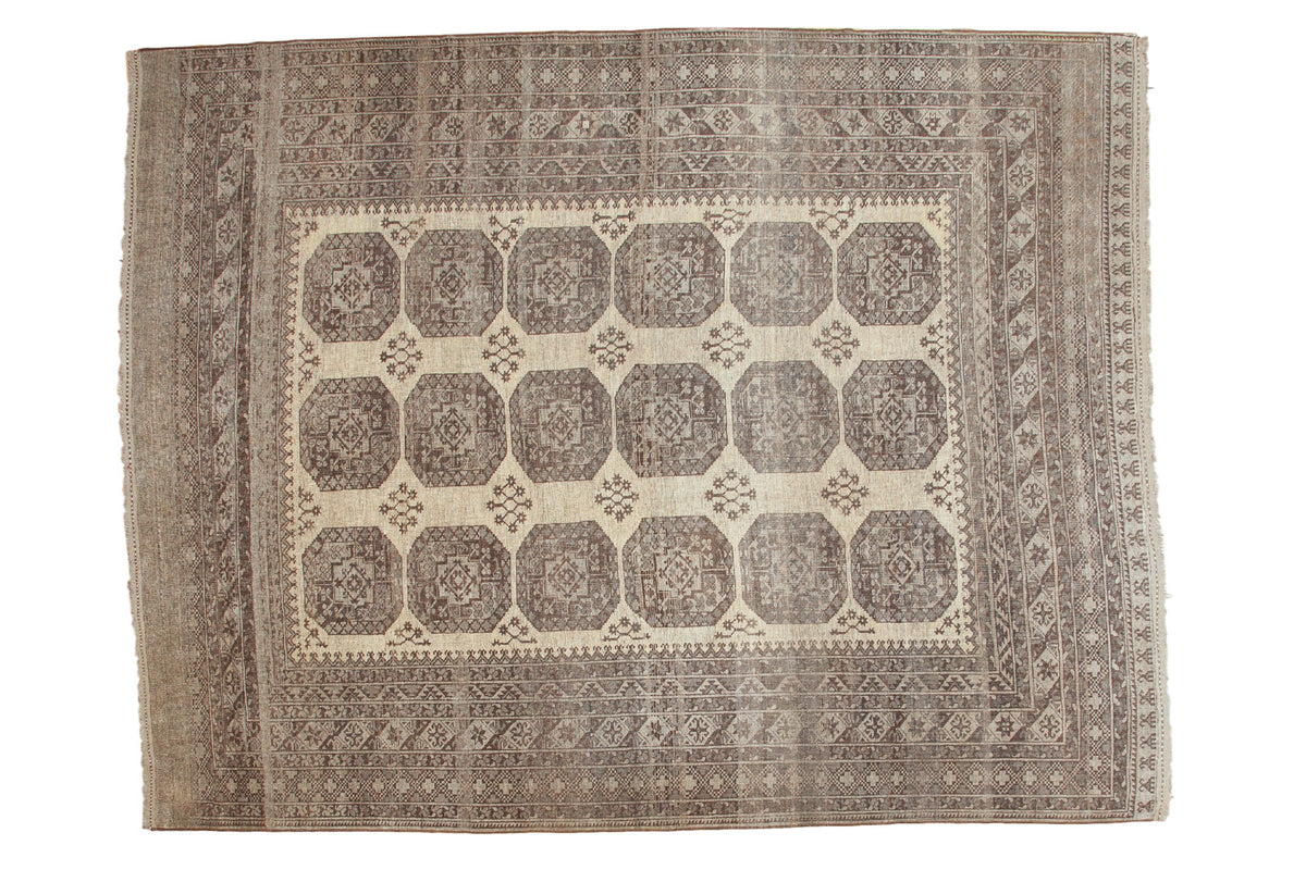 Distressed Afghan carpet featuring gul design, antique ivory, platinum, charcoal abrashes, 9'11" x 12'10".