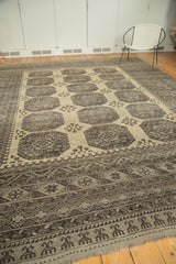 Intricate rectilinear patterns and rich abrashes on a distressed Afghan carpet border.