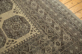 Distressed vintage Afghani carpet corner with intricate rectilinear borders and ivory gul.