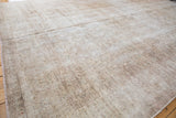 Textural surface of a distressed Turkish Sivas carpet with faded beige and ivory.