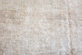 Worn aesthetic and mixed texture on distressed Sivas carpet, showing beige and antique ivory tones.
