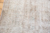 Distressed Sivas carpet with mixed texture of flat weave and low pile, in neutral and green tones.