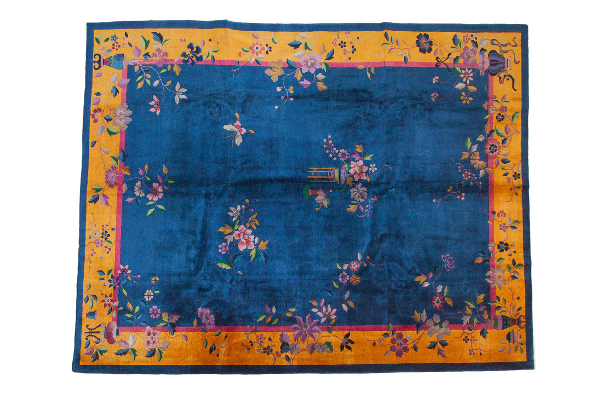 Vintage Chinese Art Deco carpet, cobalt blue field, saturated gold border, asymmetric floral.