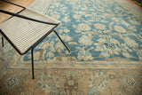 Hand knotted antique Lilihan border with beige, blue, and bronze stylized floral motifs.