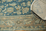 Antique Lilihan carpet's multi-layered border with stylized florals in beige and blue.