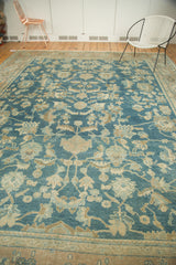 Detail of antique Fine Lilihan carpet: sprawling beige, bronze floral motifs on sky blue field.