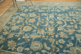 Sprawling floral design with slight asymmetry on the antique Lilihan carpet's sky blue field.