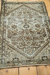 Antique Malayer rug's distressed Herati pattern in ivory, charcoal, and powder blue.