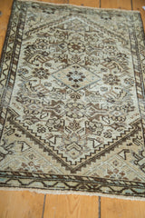 Textured close-up of antique Malayer rug's Herati pattern, with beige and powder blue.