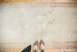 Top-down view: distressed Oushak runner with repeating hexagonal motifs and blush borders.