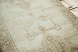 Pale wooded tone-on-tone geometric pattern on vintage Oushak rug pile.