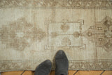 Hand-knotted vintage Oushak rug with tone-on-tone geometric medallion in pale wooded tones.