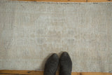 Distressed Oushak rug runner showcasing textured pile in faded beige, platinum, and silver.